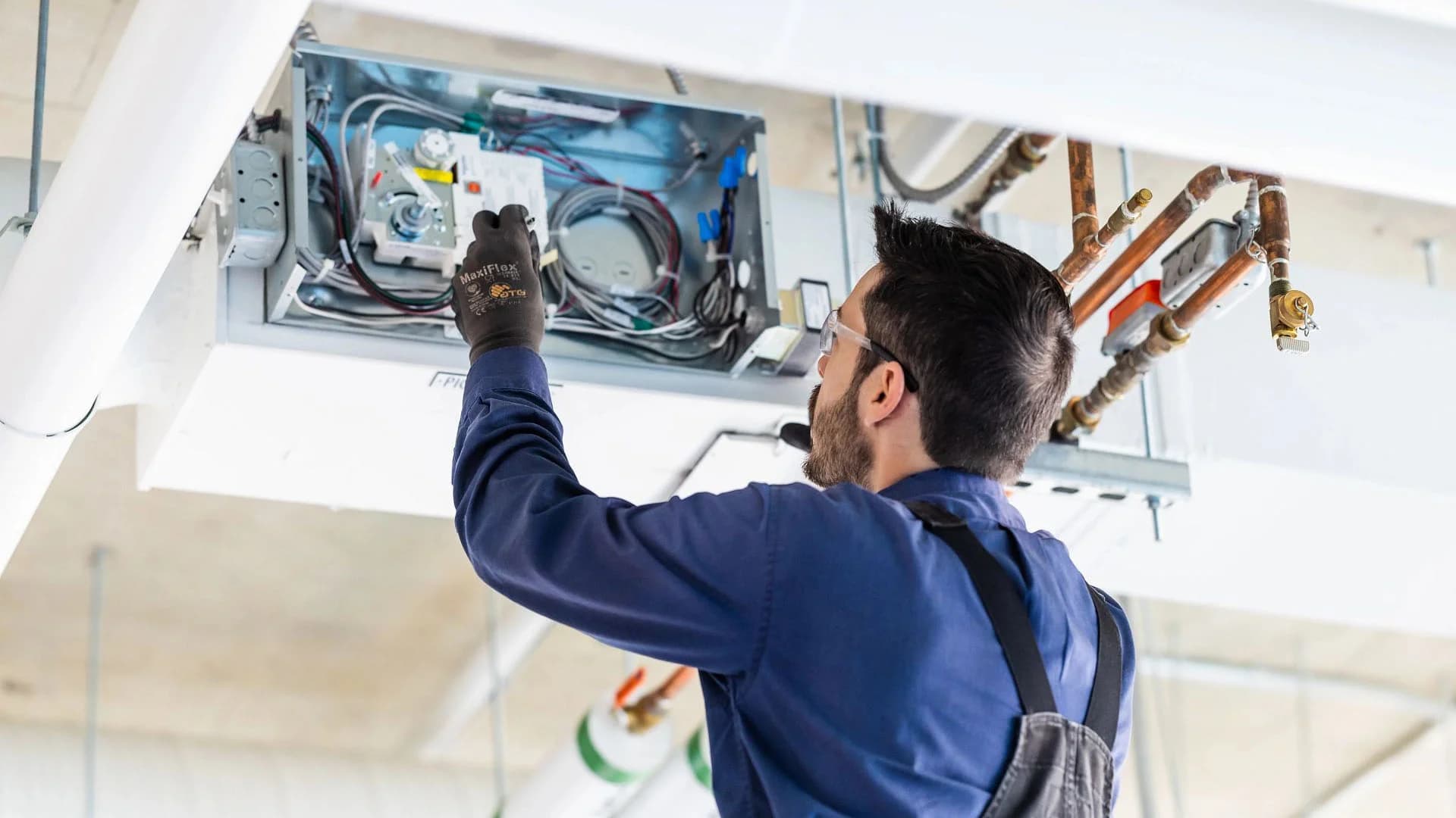 Technician checking AC coils and electrical components